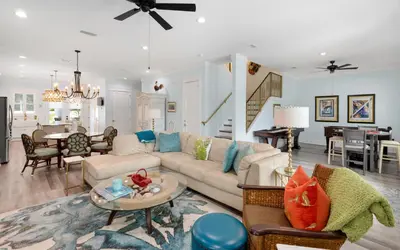 a living room with a couch and a table at Villa Dolce in Santa Rosa Beach