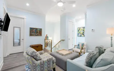 a living room with two couches and a tv at Villa Dolce in Santa Rosa Beach