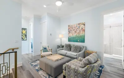 a living room with a couch and a chair at Villa Dolce in Santa Rosa Beach