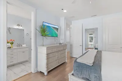 a white bedroom with a bed and a dresser at Sea Turtle House- Lux Townhome- Pool - Golf Cart in Santa Rosa Beach