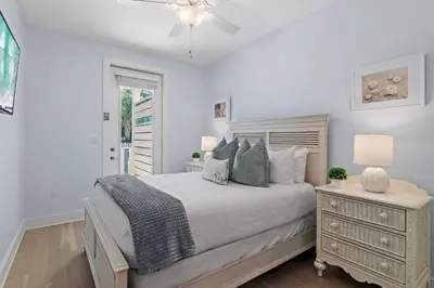 a white bedroom with a bed and a dresser at Sea Turtle House- Lux Townhome- Pool - Golf Cart in Santa Rosa Beach
