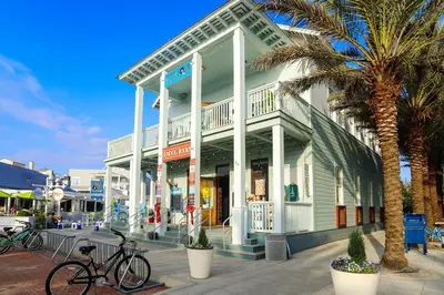 a building with two bikes parked in front of it at Sea Turtle House- Lux Townhome- Pool - Golf Cart in Santa Rosa Beach
