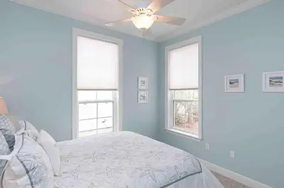 a bedroom with a bed with a ceiling fan at Rise and Shine in Santa Rosa Beach