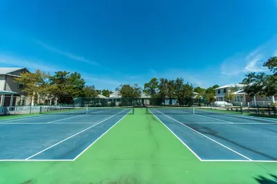 a tennis court with two tennis courts at Rise and Shine in Santa Rosa Beach