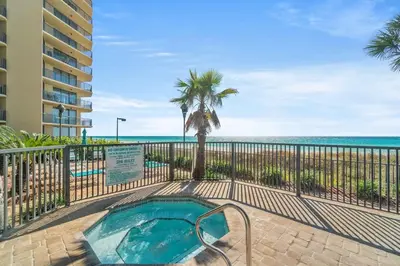 a swimming pool with a view of the beach at Breathtaking Sunset View Beachfront Condo Resort in Panama City Beach