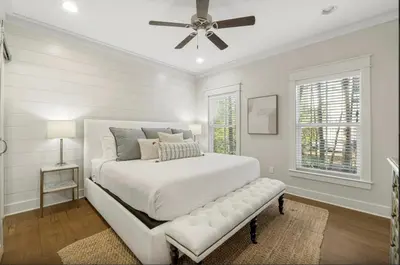 a white bedroom with a bed and a ceiling fan at Sleeps 18 | Bikes | Sunshine State of Mind | 30A | Pool | Beach Access in Inlet Beach