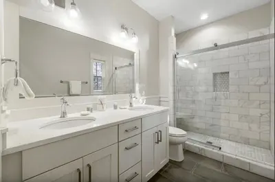 a bathroom with a sink and a toilet and a mirror at Sleeps 18 | Bikes | Sunshine State of Mind | 30A | Pool | Beach Access in Inlet Beach