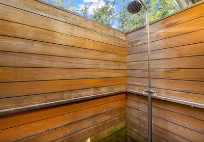 a shower stall with a wooden wall at Sleeps 18 | Bikes | Sunshine State of Mind | 30A | Pool | Beach Access in Inlet Beach
