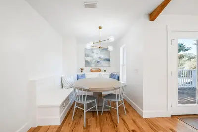 a white dining room with a table and chairs at Backyard Oasis ,Pool, Sandy Magnolia, Sleeps 16,Eastern Lake, Golf Cart,Bikes in Santa Rosa Beach