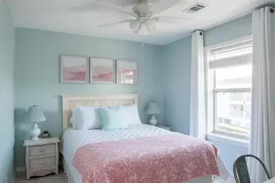 a bedroom with a bed and a ceiling fan at You are my Sunshine- Heated Pool- Steps to sand in Santa Rosa Beach