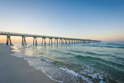 a pier stretches out into the ocean near the beach at Gulf-Front Paradise, Steps to Beach & Pool Access in Panama City Beach