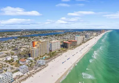an aerial view of a beach with buildings and the ocean at Gulf-Front Paradise, Steps to Beach & Pool Access in Panama City Beach