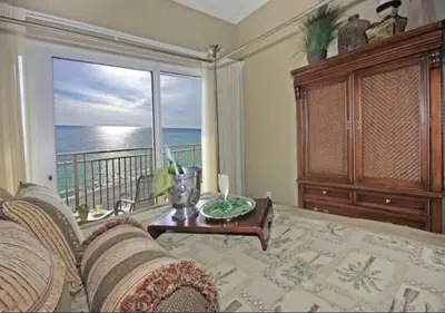a living room with a couch and a view of the ocean at Gulf-Front Paradise, Steps to Beach & Pool Access in Panama City Beach