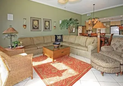 a living room with a couch and a table at Gulf-Front Paradise, Steps to Beach & Pool Access in Panama City Beach