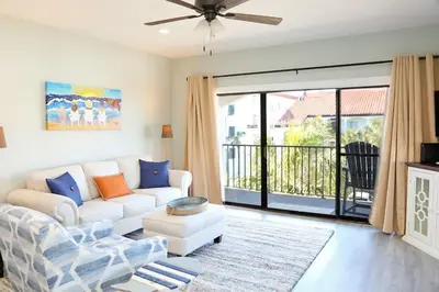 a living room with a white couch and a window at 2 The Sea- Private Beach- Pool in Santa Rosa Beach