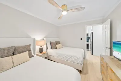 a bedroom with two beds and a flat screen tv at Beachside Villa 811 in Santa Rosa Beach