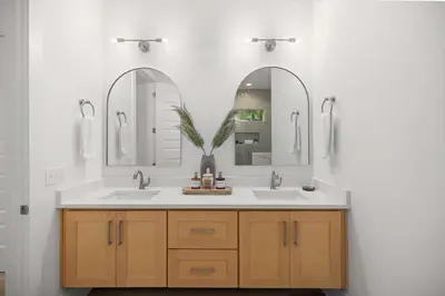 a bathroom with two sinks and two mirrors at 30A Retreat - Patio Shared Pool in Inlet Beach