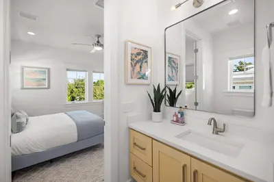 a bathroom with a bed and a sink and a mirror at 30A Retreat - Patio Shared Pool in Inlet Beach