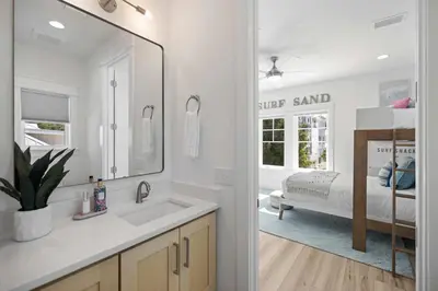 a bathroom with a sink and a bedroom with a bed at 30A Retreat - Patio Shared Pool in Inlet Beach