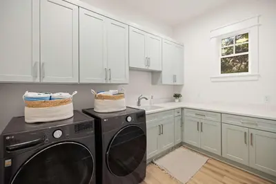 a kitchen with a black dishwasher and white cabinets at 30A Retreat - Patio Shared Pool in Inlet Beach