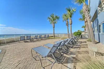a row of chairs sitting next to the beach at Ocean Reef in Panama City Beach