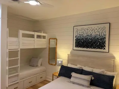 a bedroom with two bunk beds and a mirror at The Inn at Seacrest Beach Unit 207 in Rosemary Beach