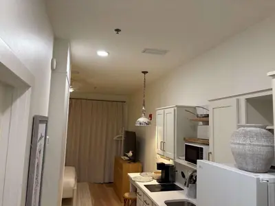a kitchen with white cabinets and a white refrigerator at The Inn at Seacrest Beach Unit 207 in Rosemary Beach
