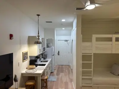 a kitchen with a counter and a bunk bed at The Inn at Seacrest Beach Unit 207 in Rosemary Beach