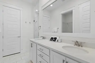 a white bathroom with two sinks and a mirror at UPDATED unit in Prominence - Resort Pool, Golf Cart on 30A in Watersound, FL in Inlet Beach