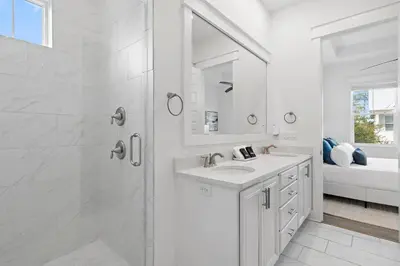 a white bathroom with a shower and a sink at UPDATED unit in Prominence - Resort Pool, Golf Cart on 30A in Watersound, FL in Inlet Beach