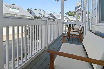 a porch with a bench and chairs on it at UPDATED unit in Prominence - Resort Pool, Golf Cart on 30A in Watersound, FL in Inlet Beach