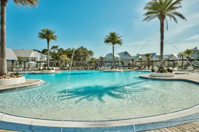 a large pool with water fountain in a resort at UPDATED unit in Prominence - Resort Pool, Golf Cart on 30A in Watersound, FL in Inlet Beach