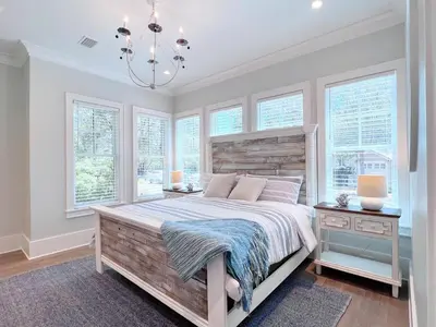 a bedroom with a large bed and windows at Watersound 13 in Watersound Beach