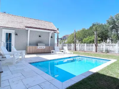 a swimming pool in a yard with white fences at Watersound 13 in Watersound Beach