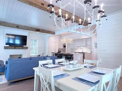 a dining room with a table and a blue couch at Watersound 13 in Watersound Beach