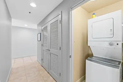 a laundry room with a washer and dryer at Sterling Breeze 607 | Gulf-Front 3BR Condo | 6th Floor Balcony, Infinity Pool, Direct Beach Access in Panama City Beach
