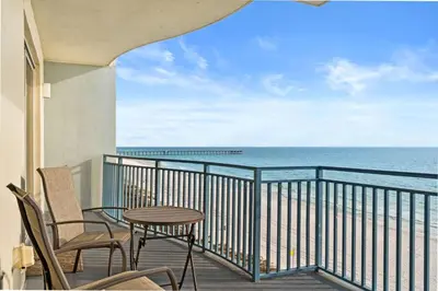 a balcony with a table and chairs and the ocean at Sterling Breeze 607 | Gulf-Front 3BR Condo | 6th Floor Balcony, Infinity Pool, Direct Beach Access in Panama City Beach