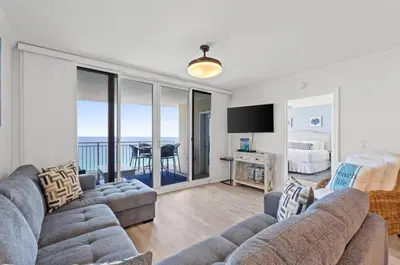 a living room with two couches and a view of the ocean at Emerald Beach 1736 by Emerald Coast Retreats in Panama City Beach
