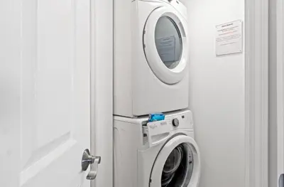 a washer and dryer in a room at Emerald Beach 1736 by Emerald Coast Retreats in Panama City Beach