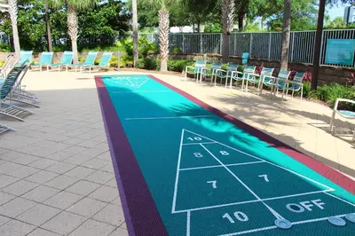 a tennis court painted on the side of a swimming pool at Emerald Beach 1736 by Emerald Coast Retreats in Panama City Beach