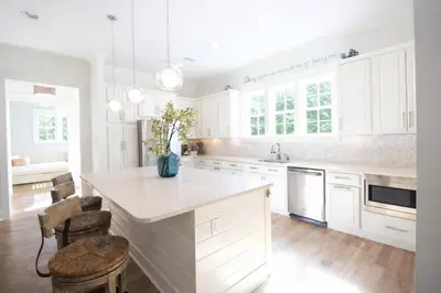 a kitchen with white cabinets and a white counter top at Second Star Shores in Watersound Beach
