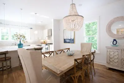 a kitchen and dining room with a wooden table and chairs at Second Star Shores in Watersound Beach