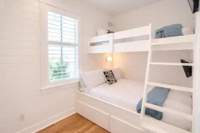 a small bedroom with a bunk bed and a window at Second Star Shores in Watersound Beach