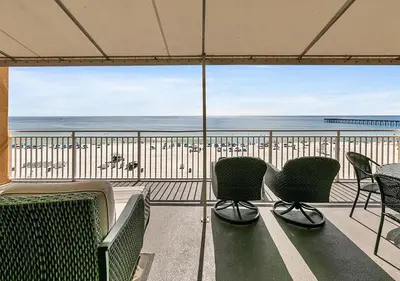 a balcony with chairs and a view of the beach at Sterling Reef 104 in Panama City Beach