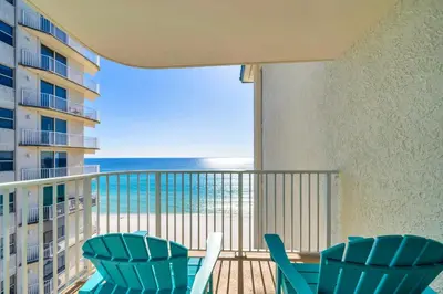 a balcony with chairs and a view of the ocean at Long Beach Resort 1-1300E in Panama City Beach