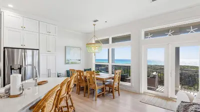 a kitchen and dining room with a table and chairs at Camelot in Seagrove Beach