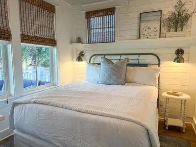 a bedroom with a bed with white sheets and a window at Bella Sol by 30A Escapes in Rosemary Beach