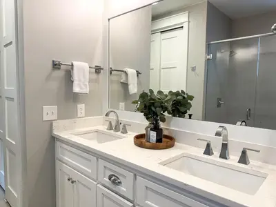 a bathroom with two sinks and a large mirror at Bella Sol by 30A Escapes in Rosemary Beach