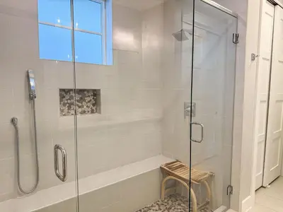 a bathroom with a shower with a glass door at Bella Sol by 30A Escapes in Rosemary Beach