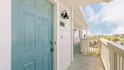 a blue door on a balcony with a view at 2 Condos Steps to Beach Ocean View Heated Pool The Sea Chord Salt Haus in Watersound Beach